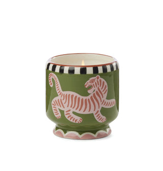 Green ceramic pedestal-style candle jar with tip of flame visible inside features a hand-painted design of a pink striped tiger below a white and black geometric top border and a pink and white scalloped border at the bottom