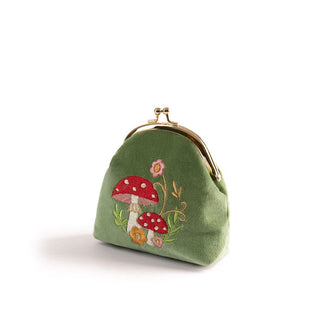 Green velvet change purse with rounded gold kiss lock top frame features an embroidered design of two red and white spotted mushrooms among delicate ferns and flowers