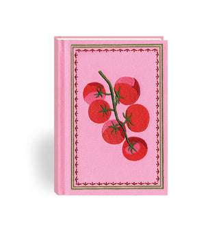 Pink cloth journal cover features embroidered design of tomatoes on the vine inside a pink and green border