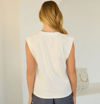 Model facing away from the camera wears a white sleeveless muscle T-shirt
