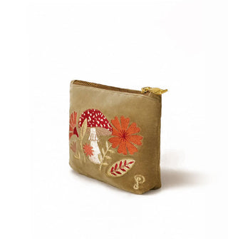 Olive green pouch with gold zipper features embroidery depicting a red and white amanita mushroom flanked by flowers and leaves in an autumnal color palette
