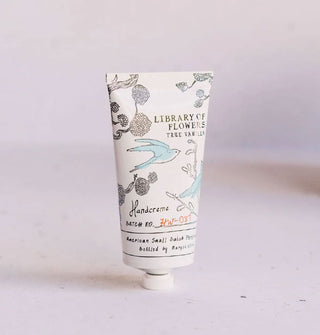 White tube of Library of Flowers True Vanilla Handcreme features delicate, monochromatic bird and flowering tree branch illustrations