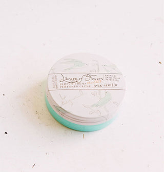 Round container of Library of Flowers True Vanilla Parfum Crema with white lid and aqua base