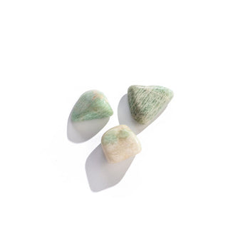 Three smooth, greenish amazonite stones in varying sizes, shapes, and patterning