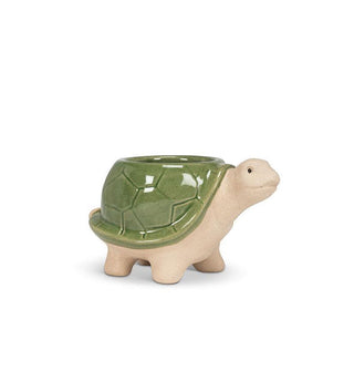 Turtle-shaped footed planter with matte beige body and face and shiny green shell