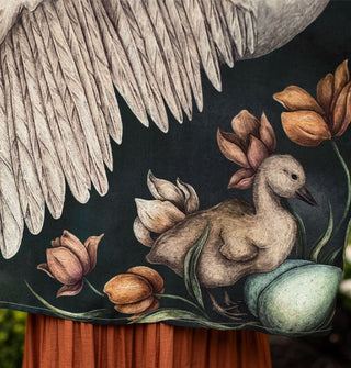 Closeup of the cygnet and eggs among flowers detailed in one corner of the cropped kimono-style Under My Wing top