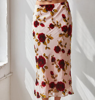 Model weard a light pink sheer lined midi skirt with large red rose print