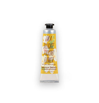 Silver tube of I'm a Delicate Fucking Flower Natural Hand Cream in Vanilla Orchid With Amber & Rosewood scent features a decorative yellow floral label and black cap