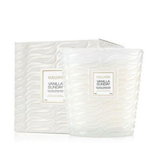 Embossed frosted white glass Vanilla Sunday Voluspa candle vessel alongside matching gift box