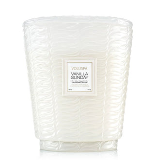 Large frosted white embossed glass Vanilla Sunday Voluspa candle jar with pedestal-style base and matching lid
