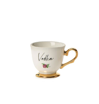 Small porcelain teacup with gold base and handle says, "Vodka" in black script with a small flower design underneath