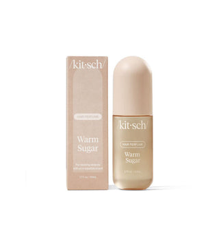 Rounded, elongated, beige-colored bottle of Kitsch Warm Sugar Hair perfume next to its box packaging