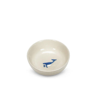Round white ceramic bowl with embossed blue whale graphic in the bottom
