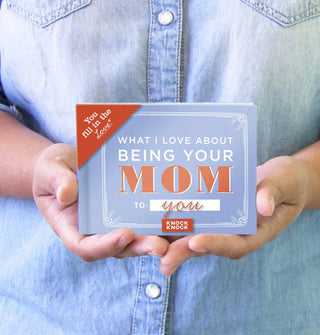 Model holds a copy of What I Love About Being Your Mom