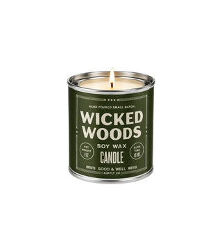 Lit 8 oz. Wicked Woods Soy Wax Candle in a metal vessel that resembles a paint can with dark green label