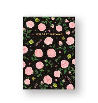 Black journal cover features various blooms, ferns, and butterflies sprinkled among larger pink rose blooms and the words, "Wildest Dreams" near the top in gold foil lettering