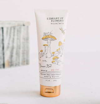 White bottle of Library of Flowers Willow & Water Shower Gel with bronze-colored cap features illustrations of yellow-capped mushrooms, a grasshopper, and a dragonfly
