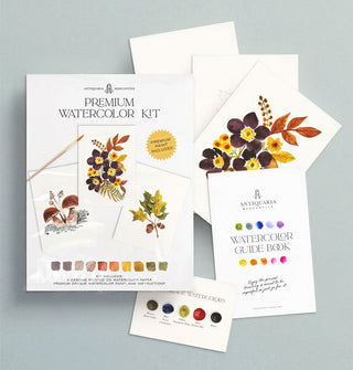 Box and components of Antiquaria Mercantile's Premium Watercolor Kit featuring floral and leaf designs