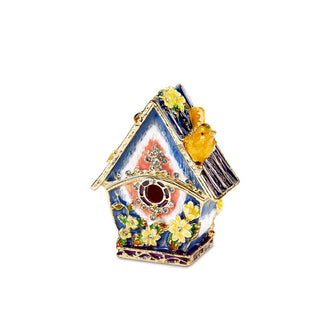 Decorative painted box designed to resemble a birdhouse with round opening, yellow bird perched on the roof, flower accents, and a gold-edged opening is accented with small, clear crystals