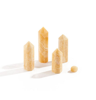 Grouping of four yellow jade points and one yellow jade nugget