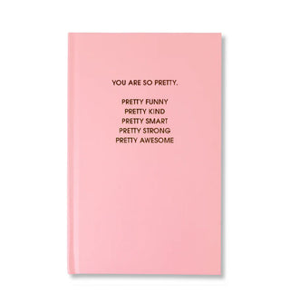 Light pink hardcover journal says, "You are so pretty. Pretty funny, pretty kind, pretty smart, pretty strong, pretty awesome" in gold foil lettering