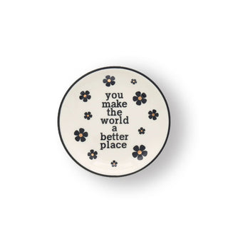 Small round white dish with black and gold flower accents and a black rim says, "YOu make the world a better place" in black lettering